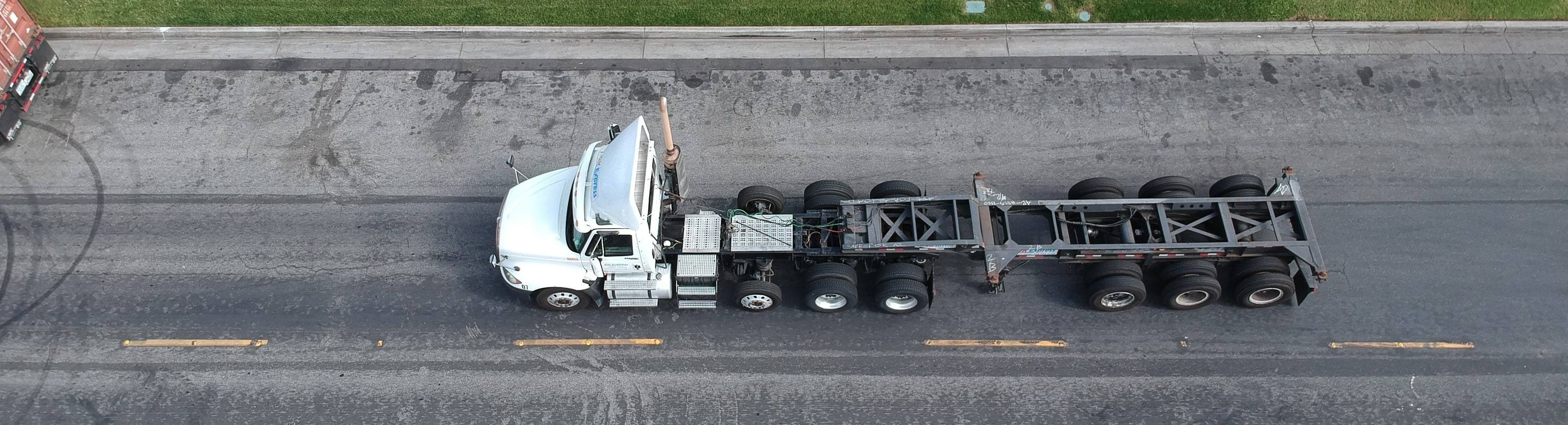 Overhead view of a DK Express day cab coupled to a container chassis