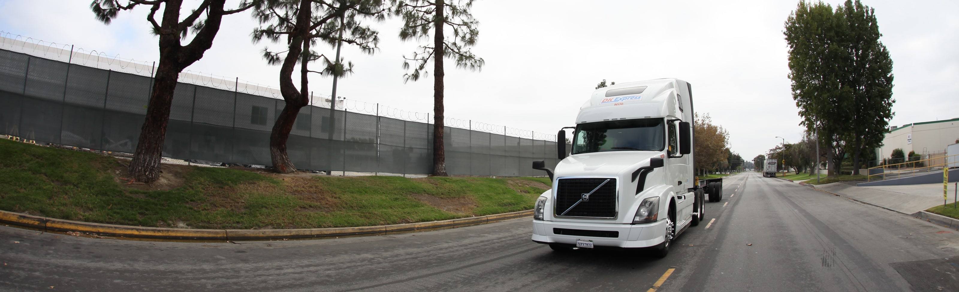 DK Express Volvo tractor 8020 driving toward the camera on a yard road